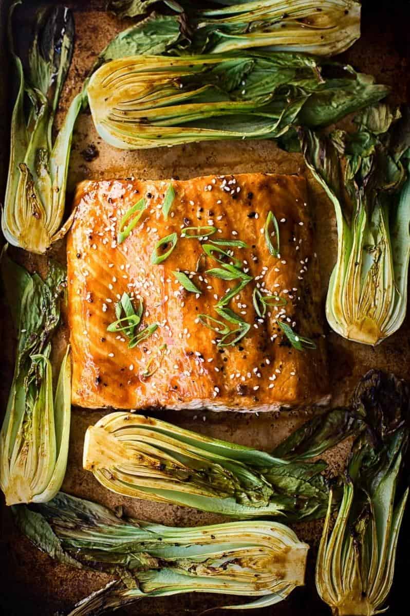  Fresh salmon fillets topped with vibrant green bok choy for a pop of color.