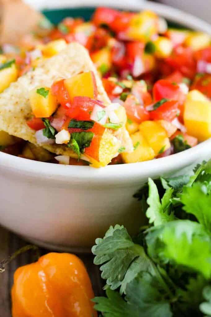  Impress your friends with this unique salsa recipe featuring grilled peaches and habanero peppers.